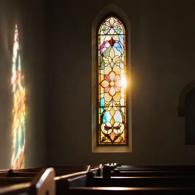 Sunlit Stained Glass Over Chapel Pews