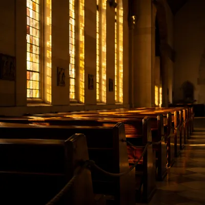 Sunlit Church Pews with Stained Glass