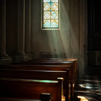 Sunlit Church Pews with Stained Glass