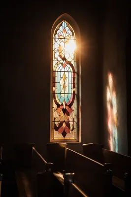 Sunlit Stained Glass Over Chapel Pews