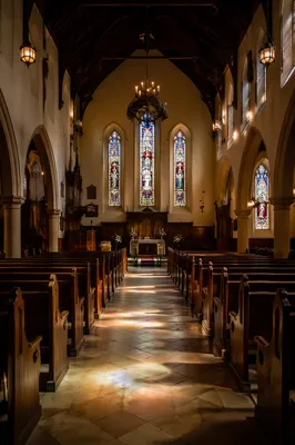 Sunlit Historic Church Nave With Wooden Pews