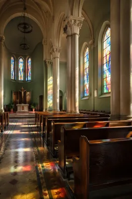 Sunlit Church Pews with Stained Glass