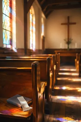 Sunlit Chapel Pews With Stained Glass