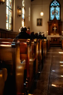 Sunlit Chapel Pews with Stained Glass