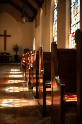 Sunlit Church Pews with Stained Glass