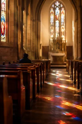 Sunlit Church Pews with Stained Glass