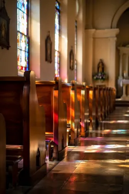 Sunlit Church Pews and Stained Glass