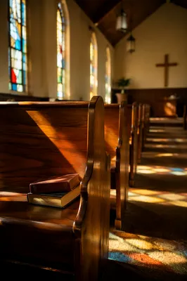 Sunlit Church Pews with Stained Glass