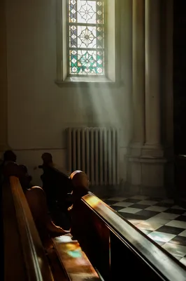 Sunlit Church Pews with Stained Glass