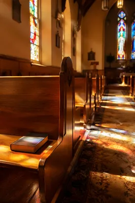 Sunlit Church Pews with Stained Glass