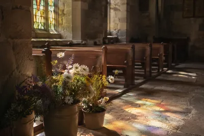 Sunlit Church Pews with Stained Glass