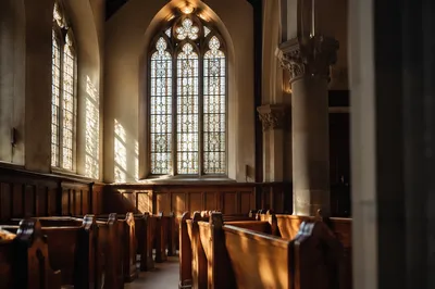 Sunlit Church Pews Beneath Stained Glass