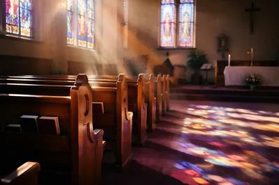 Sunlit Church Pews with Stained Glass