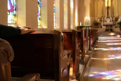 Sunlit Church Pews with Stained Glass