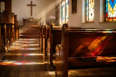 Sunlit Church Pews with Stained Glass