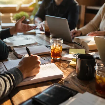 Church Staff Planning Meeting at Wooden Table
