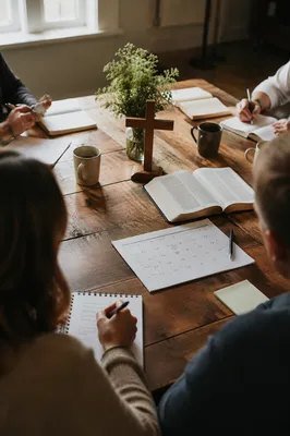 Church Staff Planning Meeting at Wooden Table