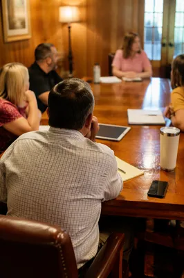 Church Staff Planning Meeting Around Wooden Table