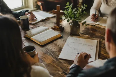 Church Staff Planning Meeting Around Wooden Table
