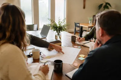 Church Staff Planning Meeting at Wooden Table