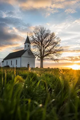 White Church Steeple Under Blue Cloudy Sky