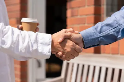 Warm Church Welcome Handshake Outside Entrance