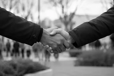 Warm Church Welcome Handshake in Courtyard