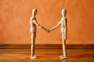 Warm Church Welcome Handshake with Wooden Mannequins