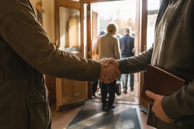 Warm Church Welcome Handshake at Chapel Doorway