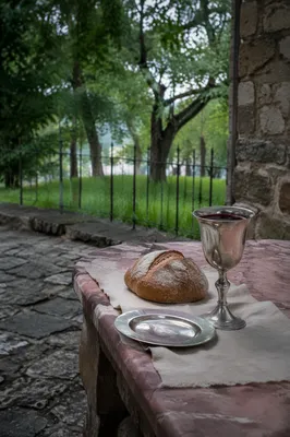 Communion Bread and Chalice in Quiet Courtyard