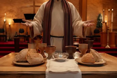 Reverent Communion Table With Bread and Chalices