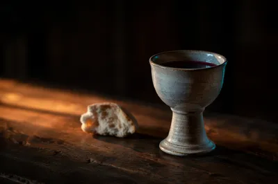 Communion Chalice and Bread on Wooden Table