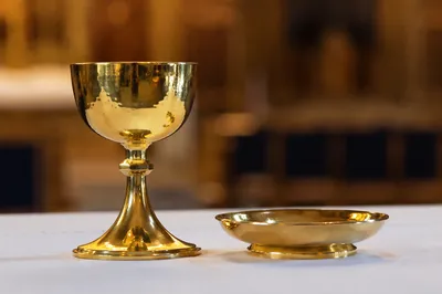 Gold Communion Chalice on White Altar Cloth