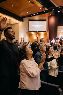 Raised Hands in Modern Church Auditorium