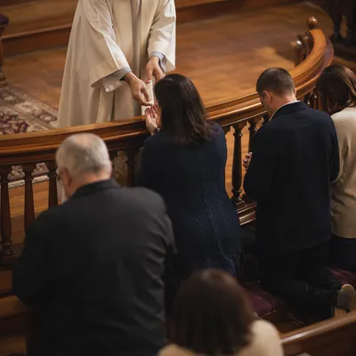 Congregation Kneeling at Communion Rail in Church