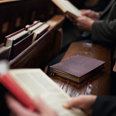Purple Hymnal on Church Pew Close-Up