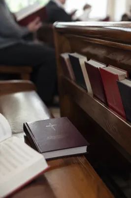 Purple Hymnal on Church Pew Close-Up