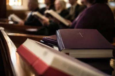Hymn Books on Church Pew During Worship