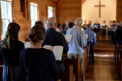 Congregation Singing Hymns in Wooden Chapel