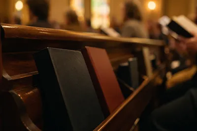 Hymn Books in Warm Church Pew