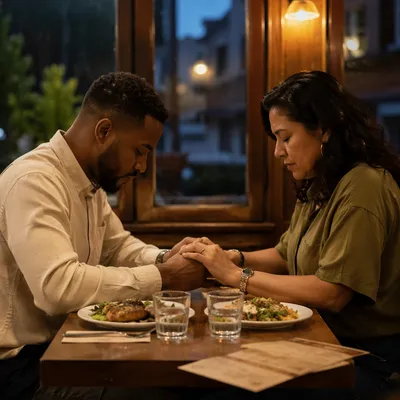 Couple Praying Before Meal at Restaurant