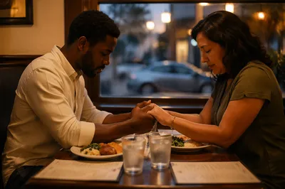 Couple Praying Before Meal at Restaurant