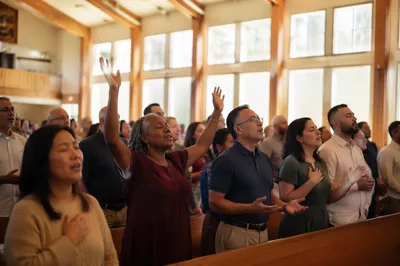 Diverse Congregation Singing in Modern Sanctuary