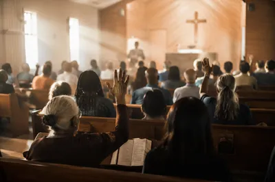 Diverse Congregation Worshiping in Wooden Chapel
