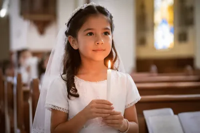Young Girl Holding Candle in Church