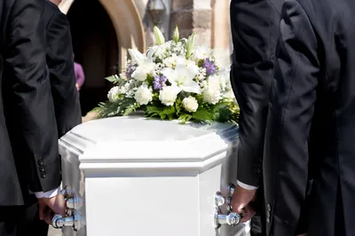Peaceful Funeral Service Casket With White Flowers