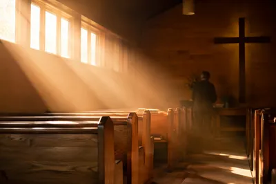 Golden Light Rays in Quiet Wooden Chapel