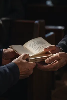 Hands Exchanging Gospel Tracts in Church