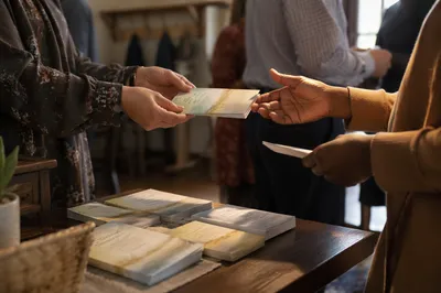 Hands Sharing Gospel Tracts in Church Foyer