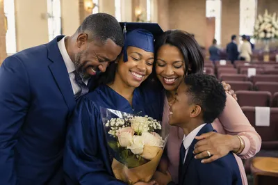 Family Hugging Graduate in Church Hall